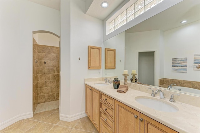 bathroom featuring shower with separate bathtub, tile patterned floors, and vanity