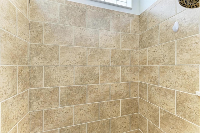 bathroom with a tile shower