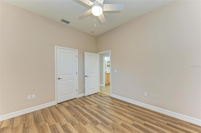 unfurnished bedroom with ceiling fan and light hardwood / wood-style floors