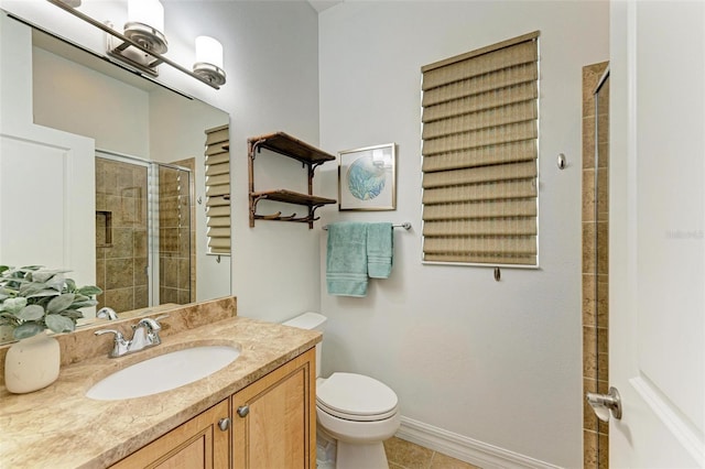 bathroom with vanity, toilet, tile patterned flooring, and a shower with door