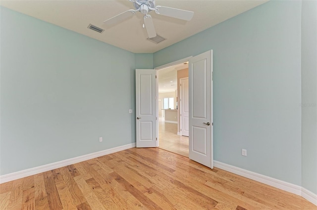 spare room with light hardwood / wood-style floors and ceiling fan