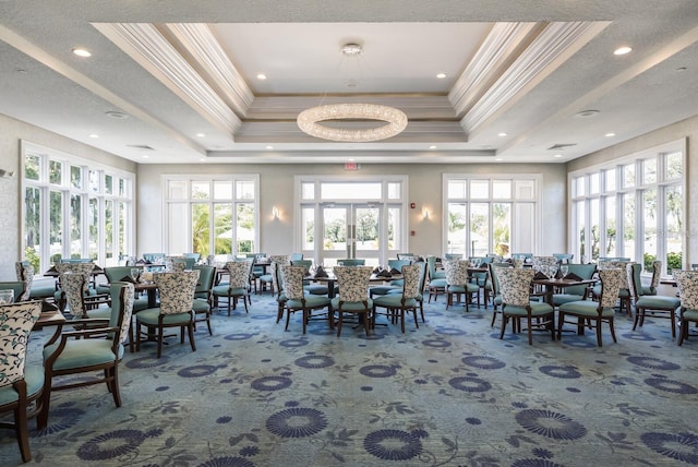 dining space featuring french doors, ornamental molding, carpet flooring, and a raised ceiling