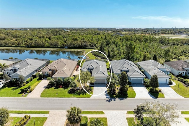 birds eye view of property featuring a residential view, a wooded view, and a water view