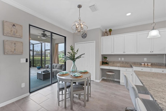 dining room featuring built in desk, ceiling fan, and crown molding