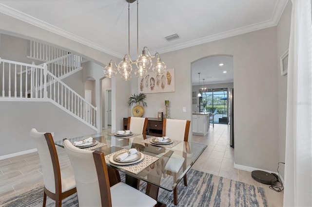 dining room featuring ornamental molding and a notable chandelier