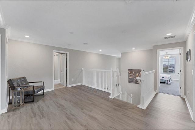 sitting room with light hardwood / wood-style floors and ornamental molding