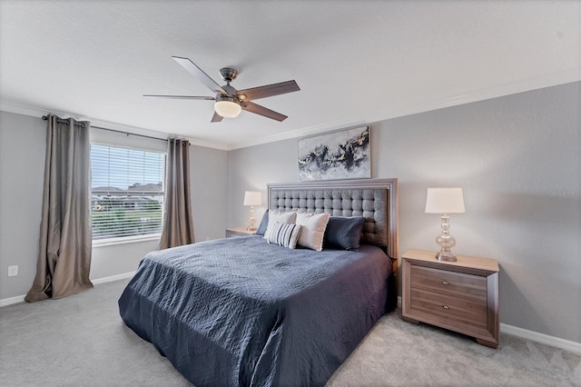 bedroom featuring ceiling fan, light carpet, and ornamental molding