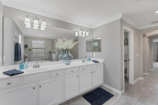 bathroom featuring tile patterned flooring, crown molding, and vanity