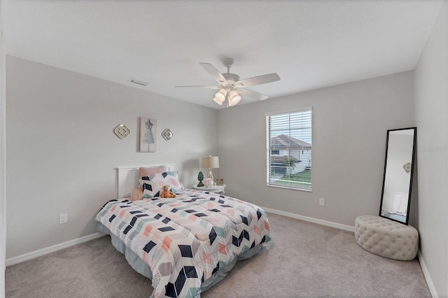 bedroom with ceiling fan and light carpet