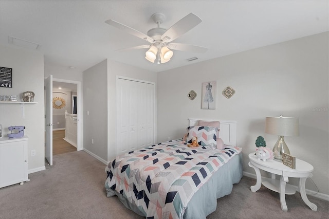 carpeted bedroom with ceiling fan and a closet