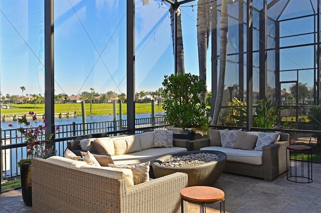 sunroom featuring a water view