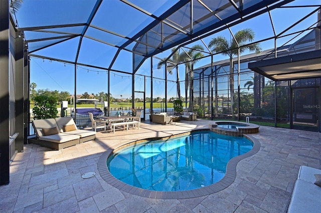 view of swimming pool featuring an in ground hot tub, a patio, a water view, and glass enclosure