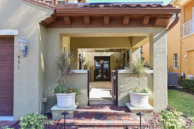 property entrance with french doors and cooling unit