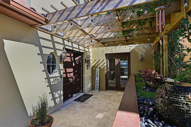 view of patio / terrace with french doors and a pergola