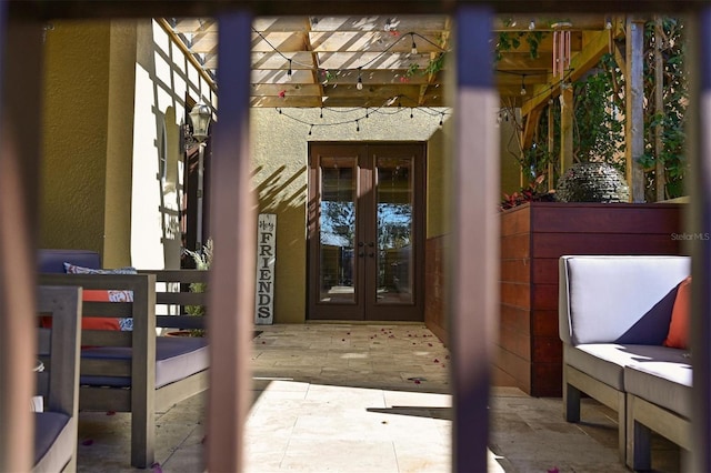 doorway to property featuring a pergola, french doors, and a patio