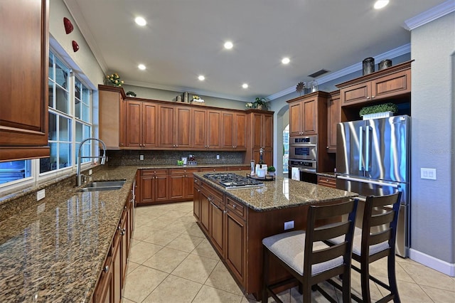 kitchen with appliances with stainless steel finishes, backsplash, crown molding, sink, and a center island