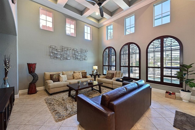 tiled living room featuring beamed ceiling, a high ceiling, ceiling fan, and coffered ceiling