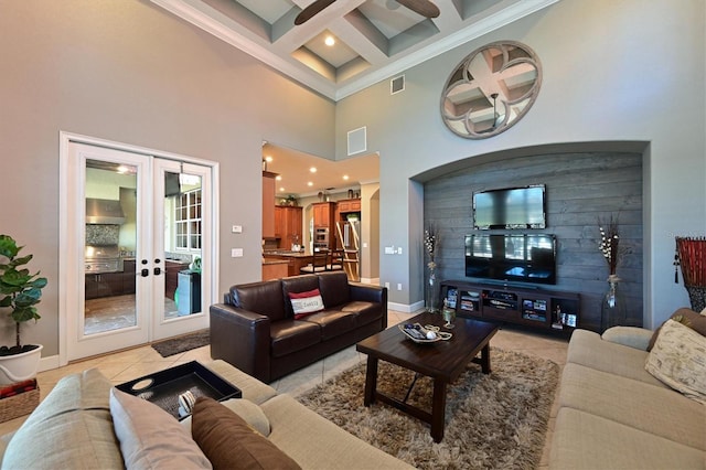 tiled living room featuring a high ceiling, coffered ceiling, french doors, ornamental molding, and beam ceiling