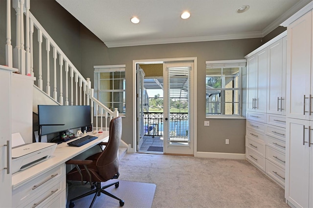 carpeted home office featuring crown molding