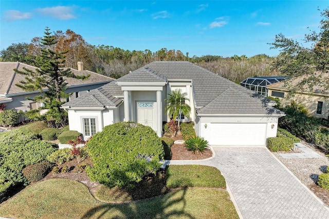 view of front of house featuring a garage and a front lawn