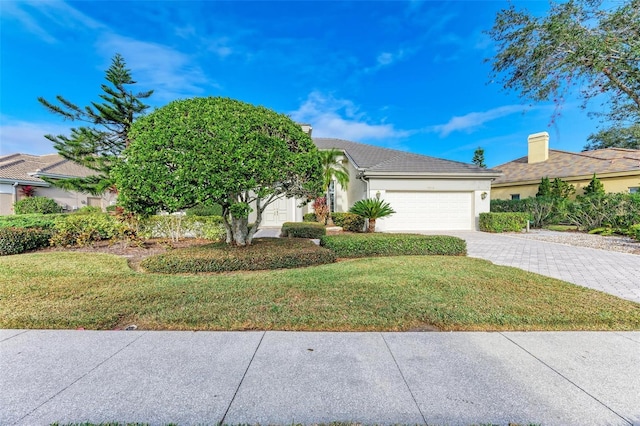 view of front of property featuring a garage and a front lawn