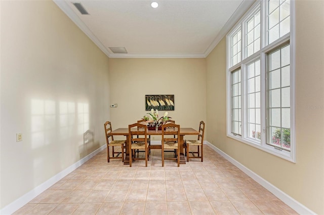 dining space with crown molding and light tile patterned floors