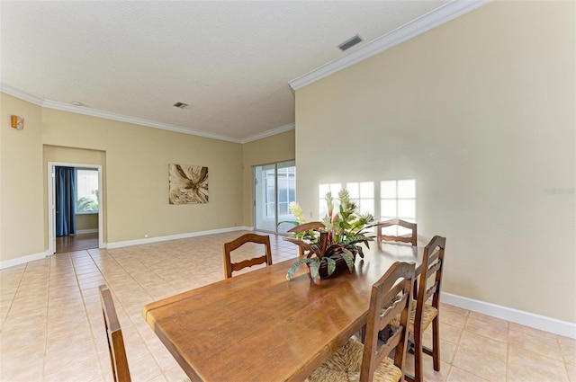 tiled dining area featuring crown molding and a textured ceiling