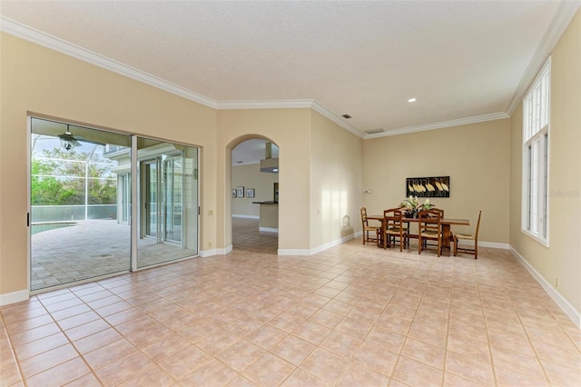 unfurnished dining area with light tile patterned flooring, crown molding, and a textured ceiling