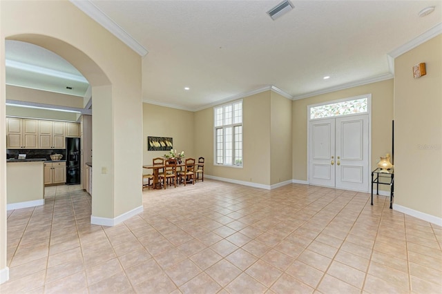 tiled foyer with ornamental molding