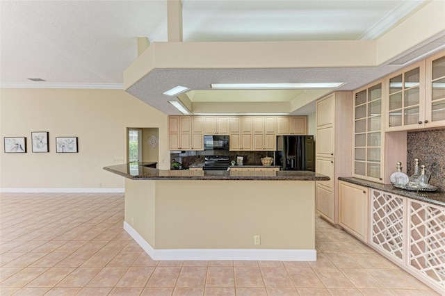 kitchen featuring dark stone countertops, tasteful backsplash, black appliances, and light tile patterned flooring