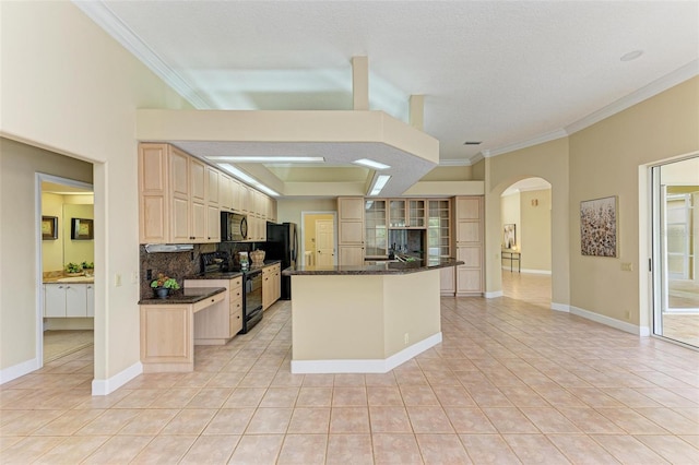 kitchen featuring decorative backsplash, a center island, light tile patterned floors, black appliances, and crown molding