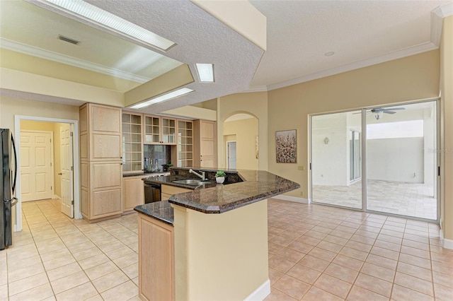 kitchen with black appliances, sink, light brown cabinets, and dark stone counters