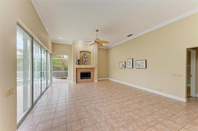 unfurnished living room featuring crown molding, ceiling fan, a tile fireplace, and light tile patterned floors