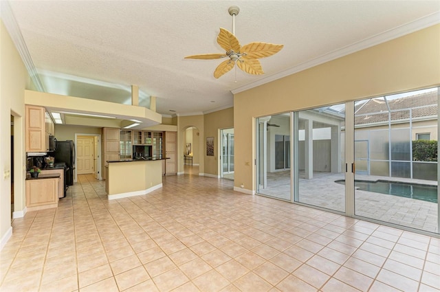 unfurnished living room with a textured ceiling, ornamental molding, ceiling fan, and light tile patterned flooring