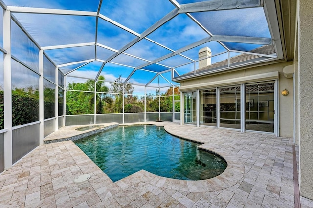 view of pool featuring an in ground hot tub, a patio, and glass enclosure