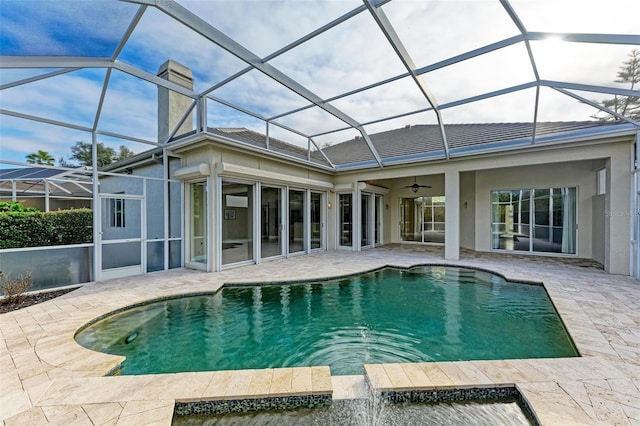 view of pool with ceiling fan, a lanai, and a patio