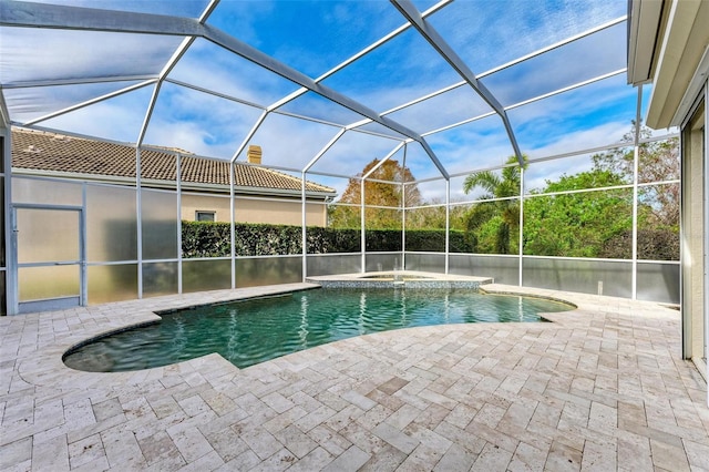 view of pool with an in ground hot tub, a lanai, and a patio