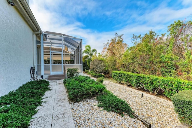 view of yard with glass enclosure