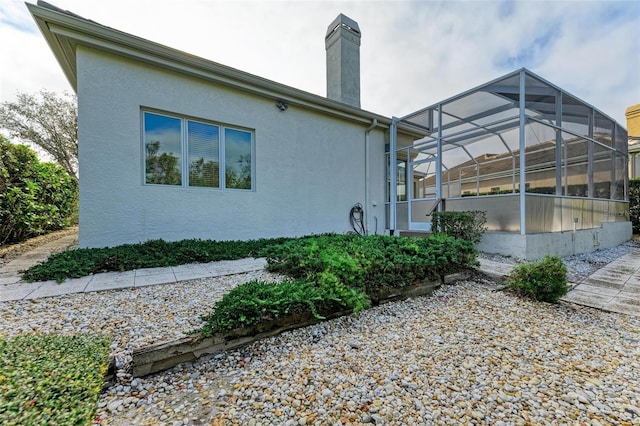 view of side of property with a lanai