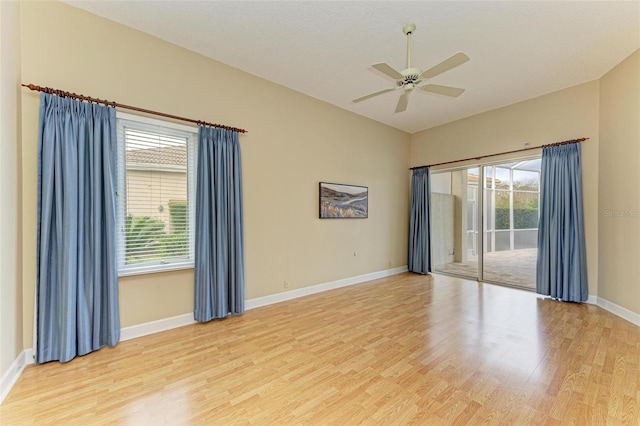 empty room featuring ceiling fan, lofted ceiling, and light hardwood / wood-style floors