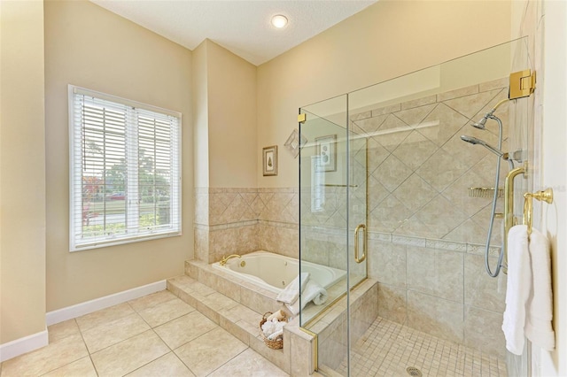 bathroom with tile patterned floors, shower with separate bathtub, and a textured ceiling