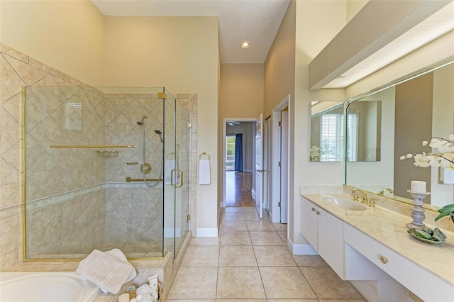 bathroom with vanity, tile patterned flooring, plus walk in shower, and a healthy amount of sunlight