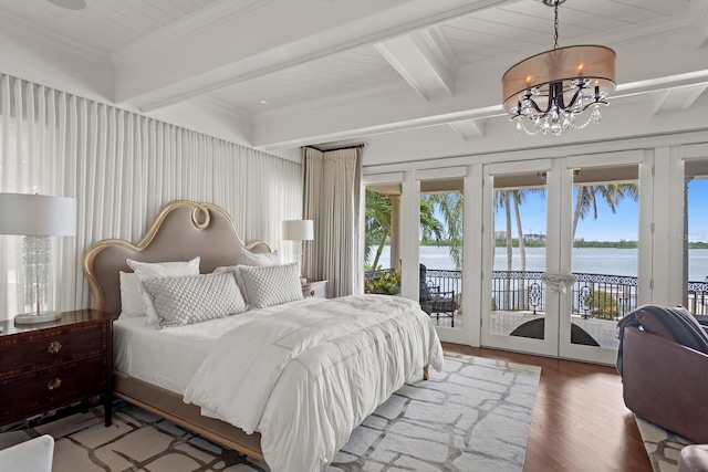 bedroom with a water view, access to exterior, wood-type flooring, french doors, and beam ceiling