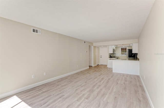 unfurnished living room featuring light hardwood / wood-style floors