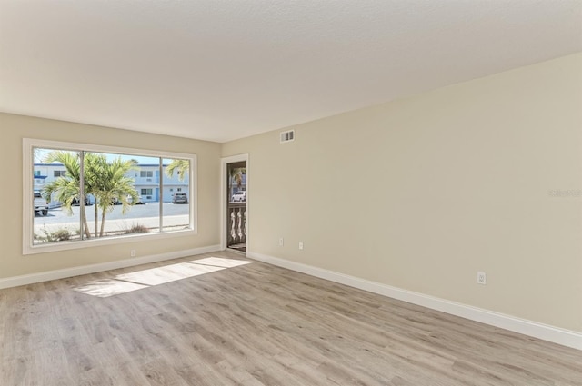 spare room with light hardwood / wood-style floors