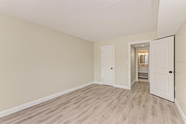 unfurnished bedroom featuring a closet and light hardwood / wood-style flooring