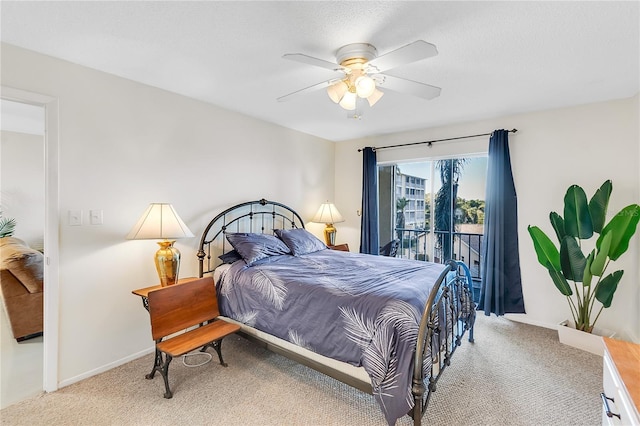 carpeted bedroom with ceiling fan and access to exterior