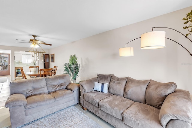 living room featuring ceiling fan and sink