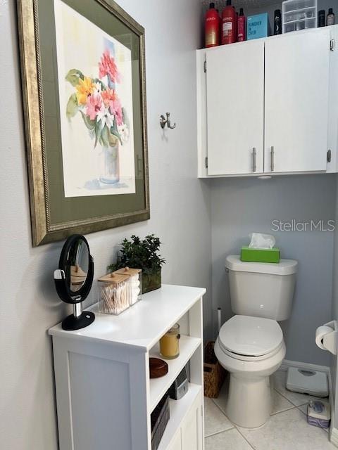 bathroom with tile patterned flooring and toilet