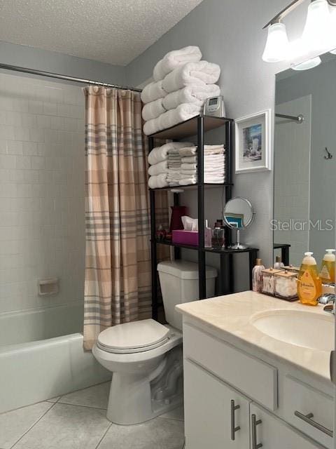 full bathroom featuring shower / bath combo, tile patterned floors, vanity, a textured ceiling, and toilet